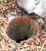 A Victorian brick-lined well at Castle Gardens in Sherborne, Dorset.  